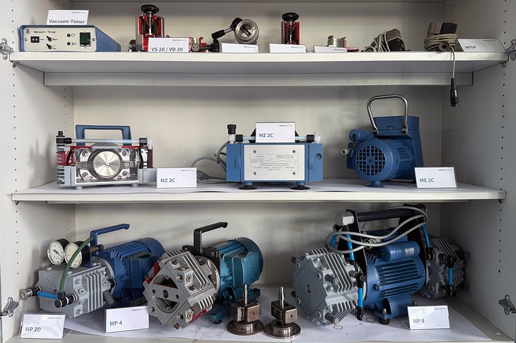Historical exhibition of earlier VACUUBRAND vacuum pumps on a shelf